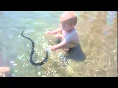 Russian Child Plays With Water Snake